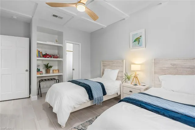 a bedroom with a bed and painting on the wall