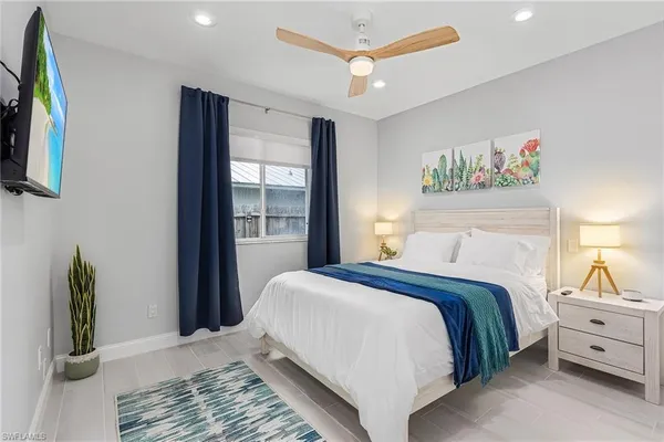 a bedroom with a large bed and a window