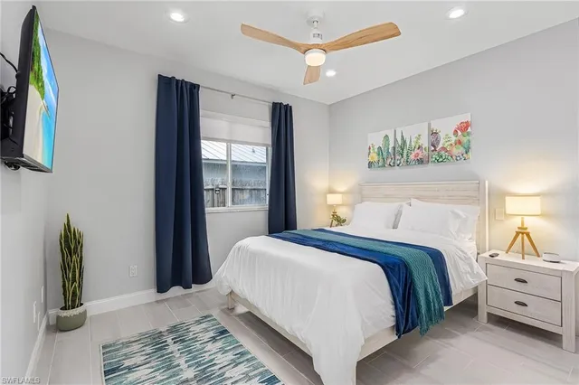 a bedroom with a large bed and a window