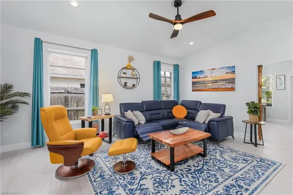 a living room with furniture a rug and a window