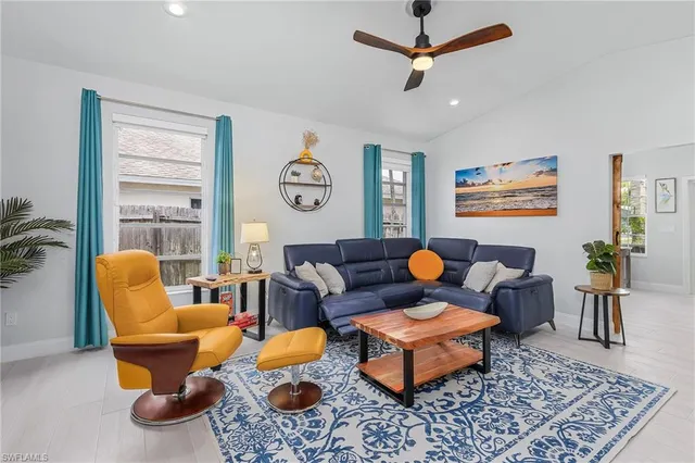 a living room with furniture a rug and a window