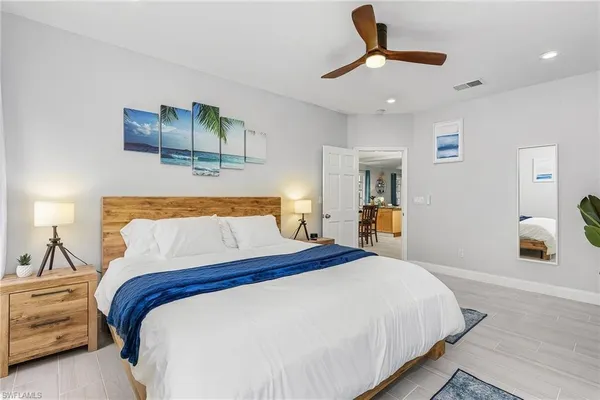 a bedroom with a bed and a chandelier