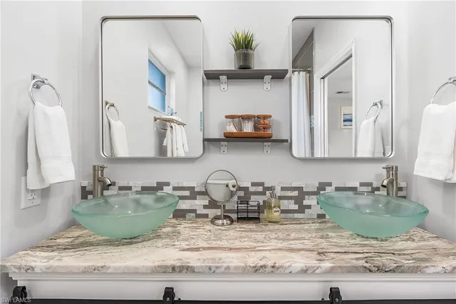 a view of a kitchen with sink and refrigerator