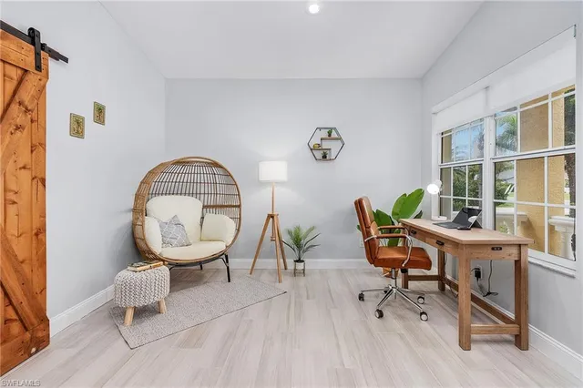 a living room with furniture a rug and a large window