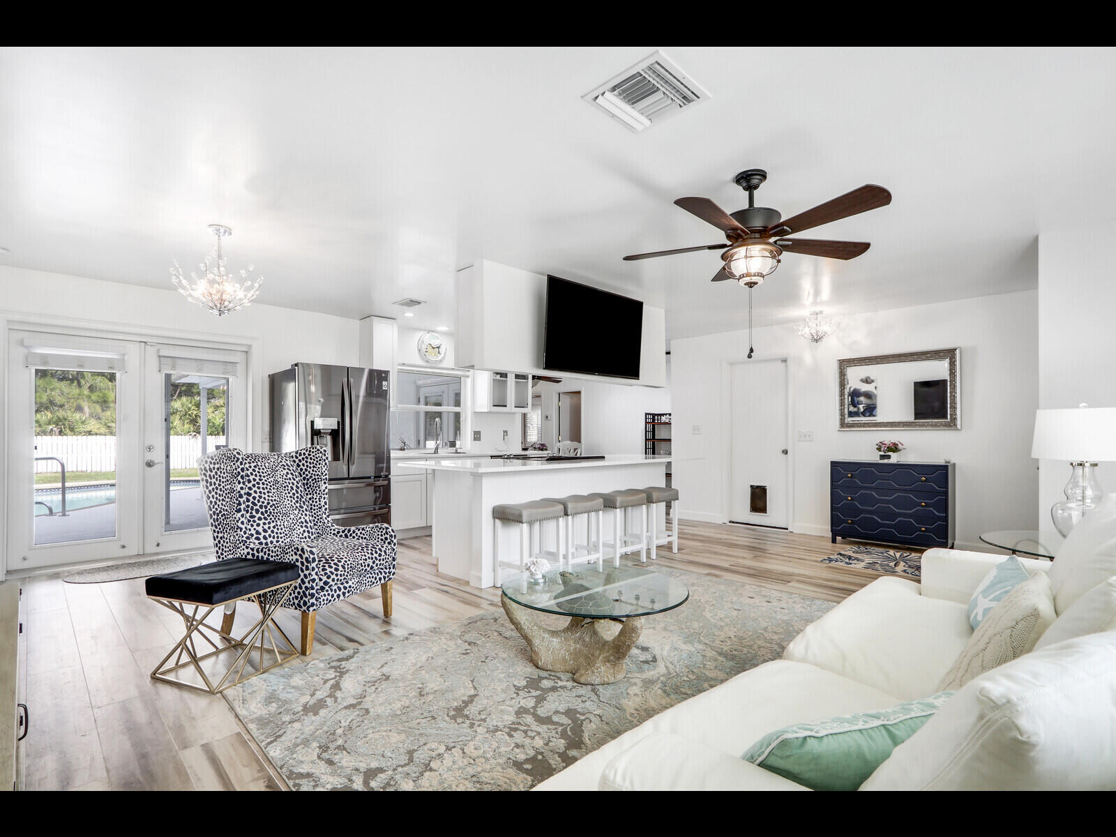 609 Oak Terrace Jupiter, FL 33458 - Photo 7 of 28 a living room with furniture a flat screen tv and kitchen view