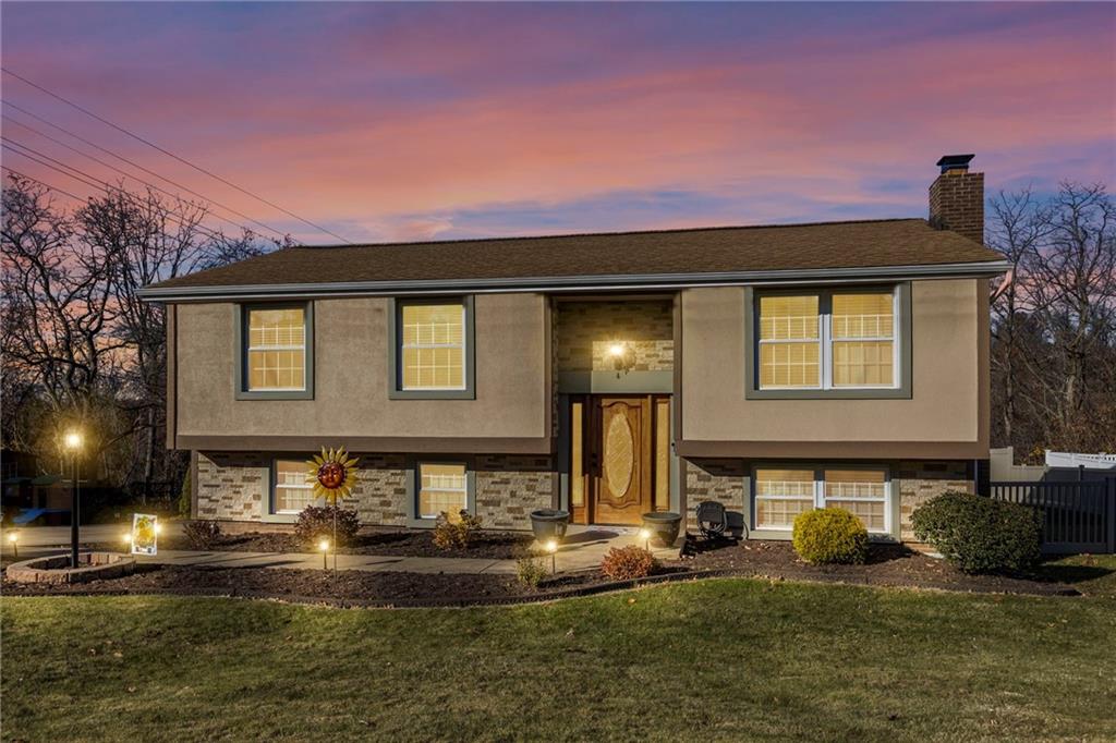 a front view of a house with swimming pool and a yard