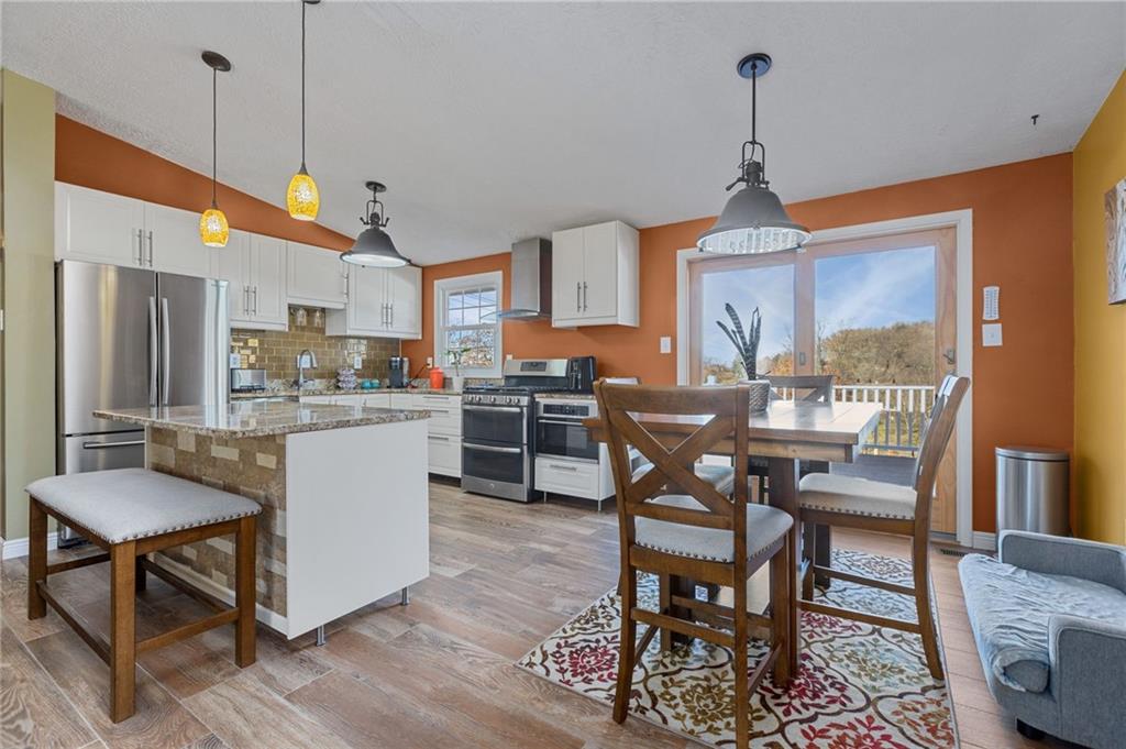 110 Tory Road Coraopolis, PA 15108 - Photo 4 of 19 a dining room with furniture a chandelier and wooden floor