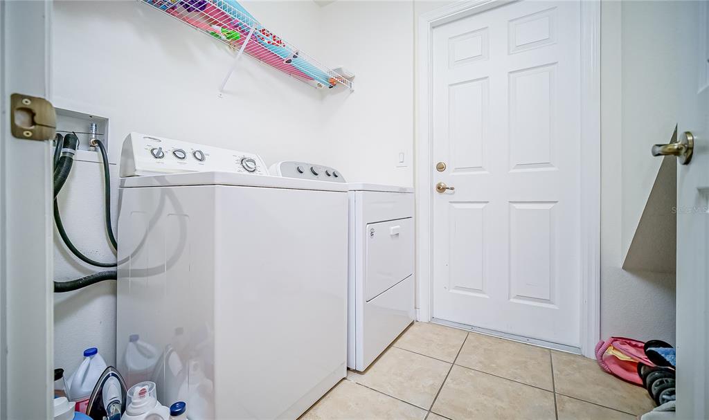 2528 Dharma Circle Kissimmee, FL 34746 - Photo 12 of 46 a utility room with dryer and washer