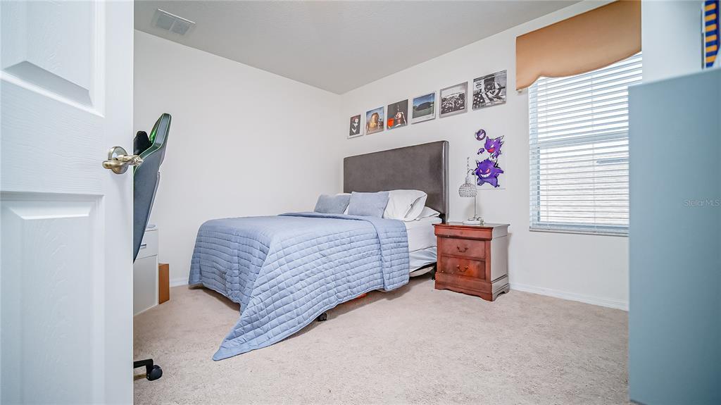 2528 Dharma Circle Kissimmee, FL 34746 - Photo 16 of 46 a bedroom with a bed and a window