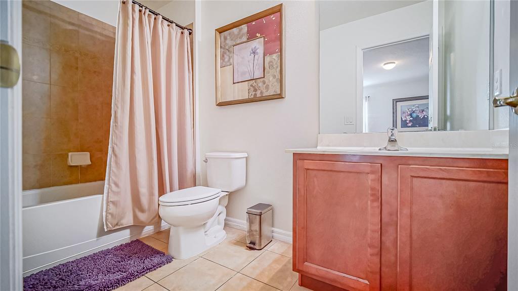 2528 Dharma Circle Kissimmee, FL 34746 - Photo 24 of 46 a bathroom with a sink a toilet and shower