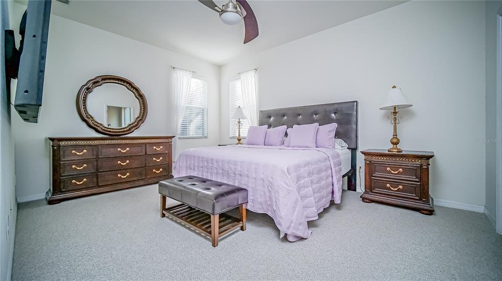 2528 Dharma Circle Kissimmee, FL 34746 - Photo 26 of 46 a bedroom with a bed a dresser and a potted plant on the dresser