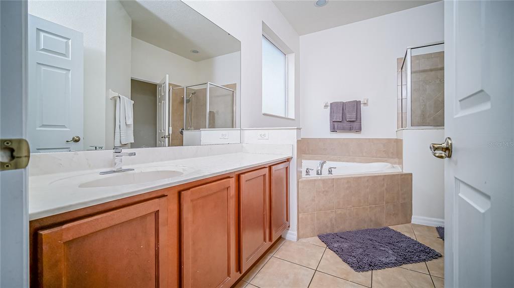 2528 Dharma Circle Kissimmee, FL 34746 - Photo 27 of 46 a bathroom with a sink a vanity and a mirror
