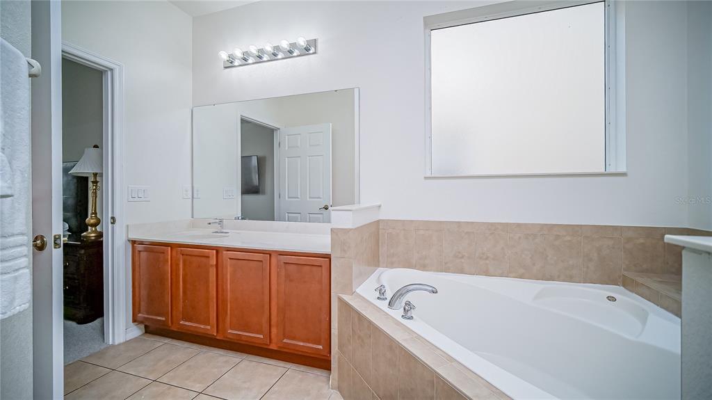 2528 Dharma Circle Kissimmee, FL 34746 - Photo 28 of 46 a bathroom with a bathtub and a sink