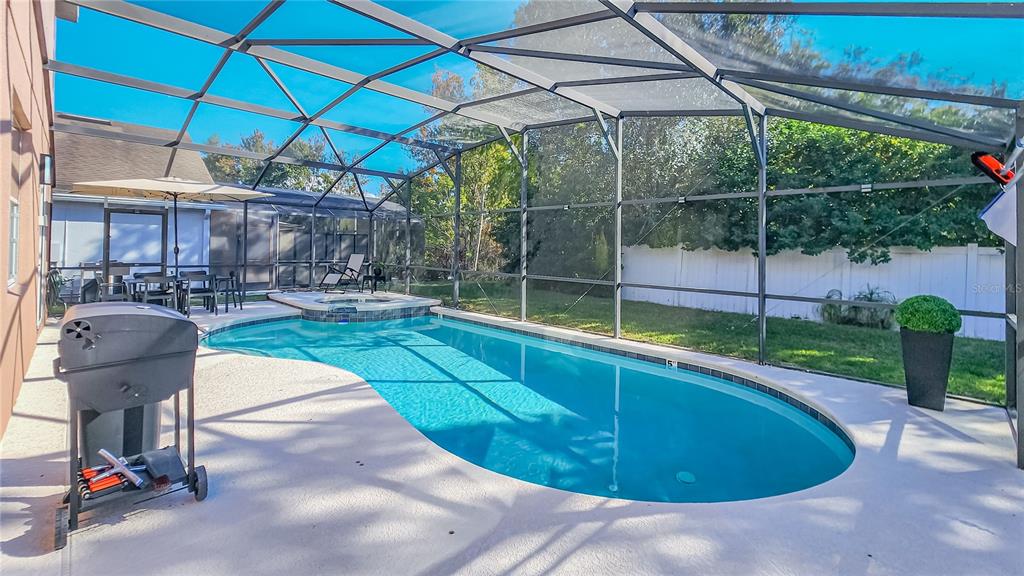 2528 Dharma Circle Kissimmee, FL 34746 - Photo 34 of 46 a view of a backyard with table and chairs under an umbrella