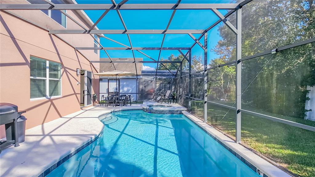 2528 Dharma Circle Kissimmee, FL 34746 - Photo 36 of 46 a view of a patio with chairs under an umbrella