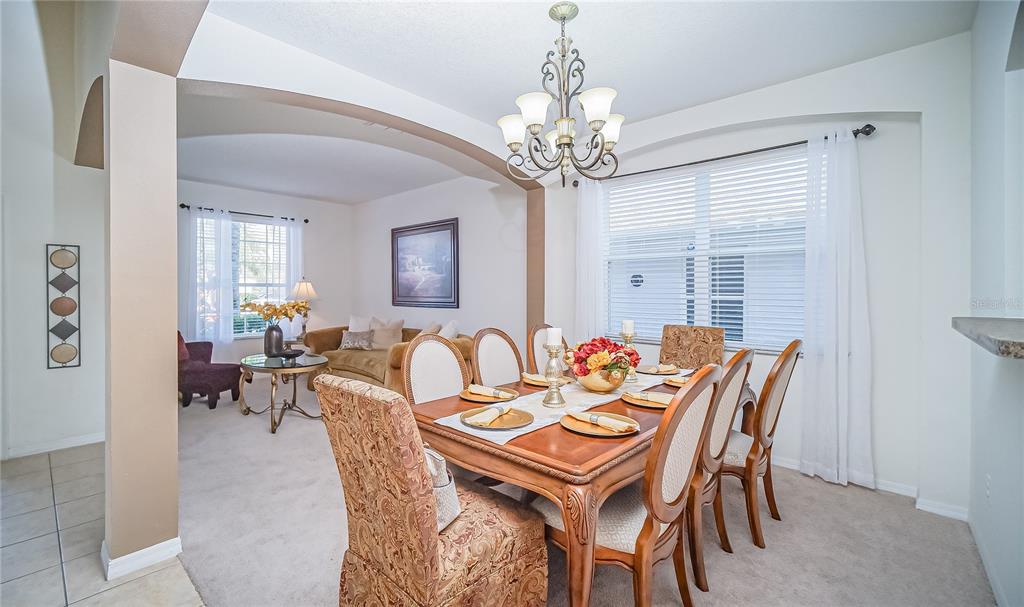 2528 Dharma Circle Kissimmee, FL 34746 - Photo 8 of 46 a view of a dining room with furniture a chandelier and window