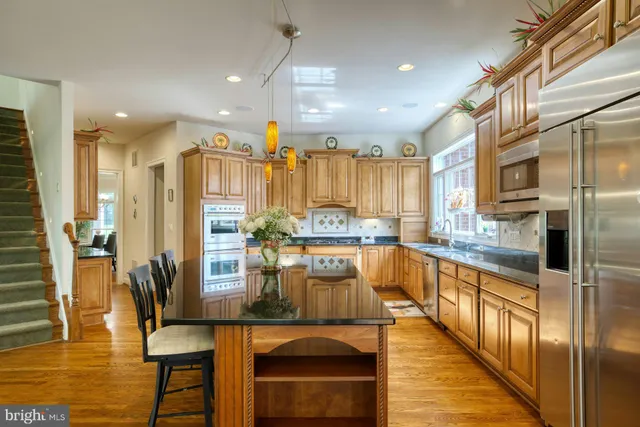 a kitchen with stainless steel appliances granite countertop a stove and cabinets