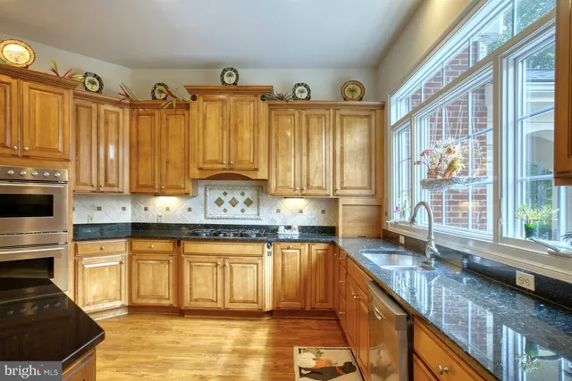 a view of a dining room with furniture a chandelier and wooden floor