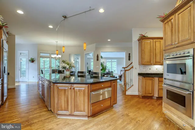 a living room with furniture fireplace and a large window