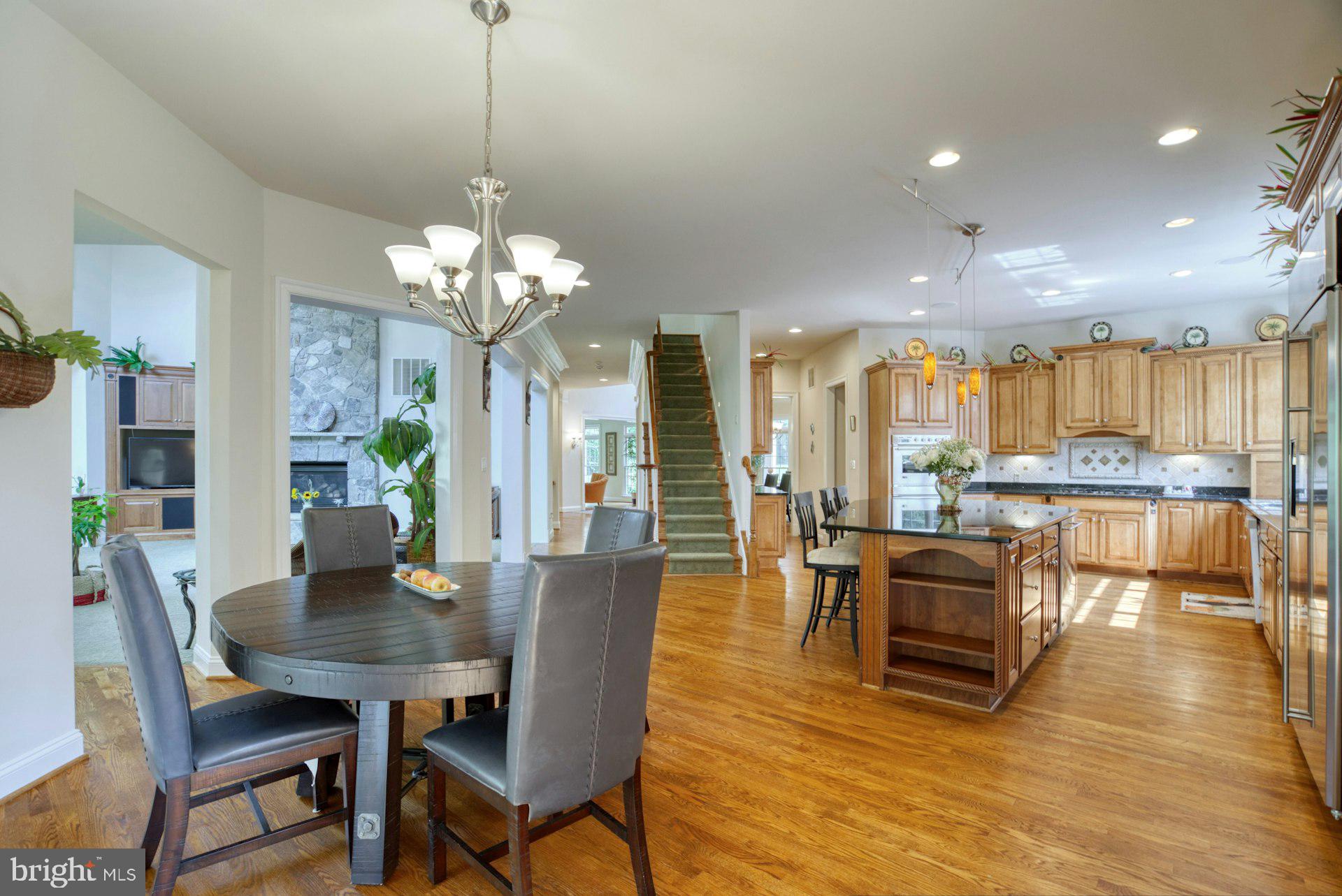 10300 Hampton Road Fairfax Station, VA 22039 - Photo 23 of 89 a view of a dining room with furniture a chandelier and wooden floor