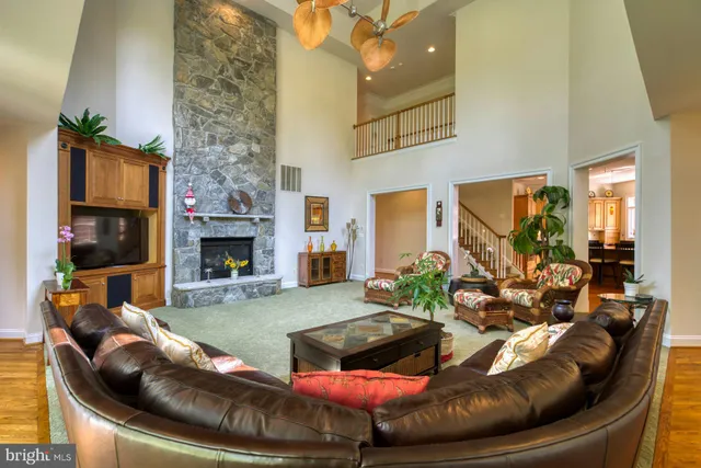 a spacious bedroom with a bed and a ceiling fan