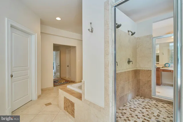 a front view of multi story residential apartment building with yard and green space