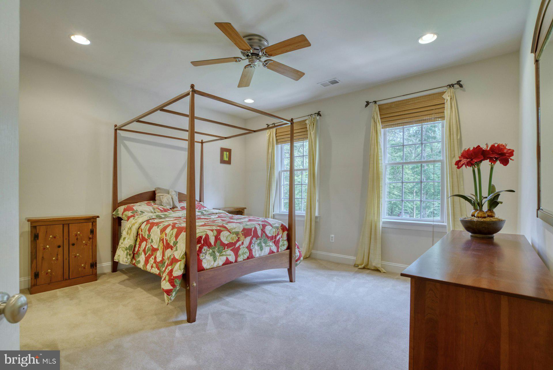 10300 Hampton Road Fairfax Station, VA 22039 - Photo 51 of 89 a bedroom with a bed and a chandelier