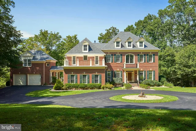 a front view of a house with yard and green space