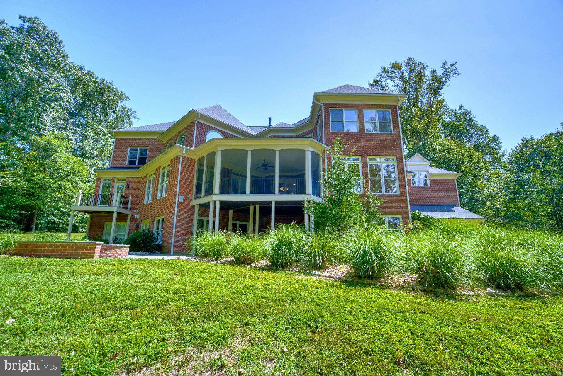 10300 Hampton Road Fairfax Station, VA 22039 - Photo 73 of 89 a front view of multi story residential apartment building with yard and green space