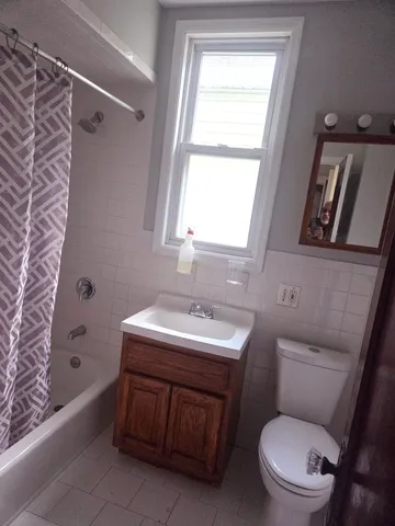 a bathroom with a sink toilet vanity and bathtub