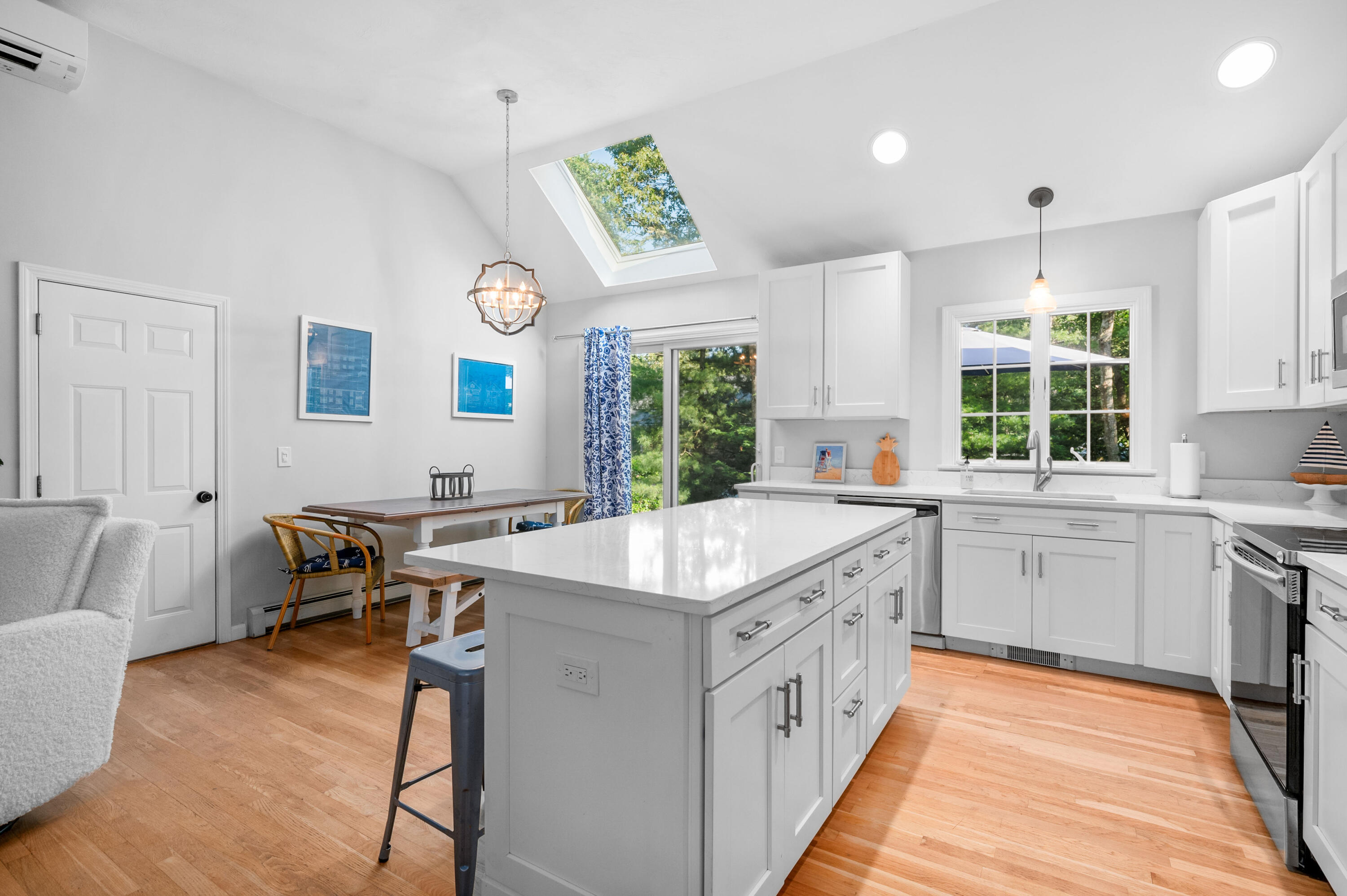 11 Quanset Road Orleans, MA 02653 - Photo 11 of 36 a kitchen with a stove a sink a dining table and chairs