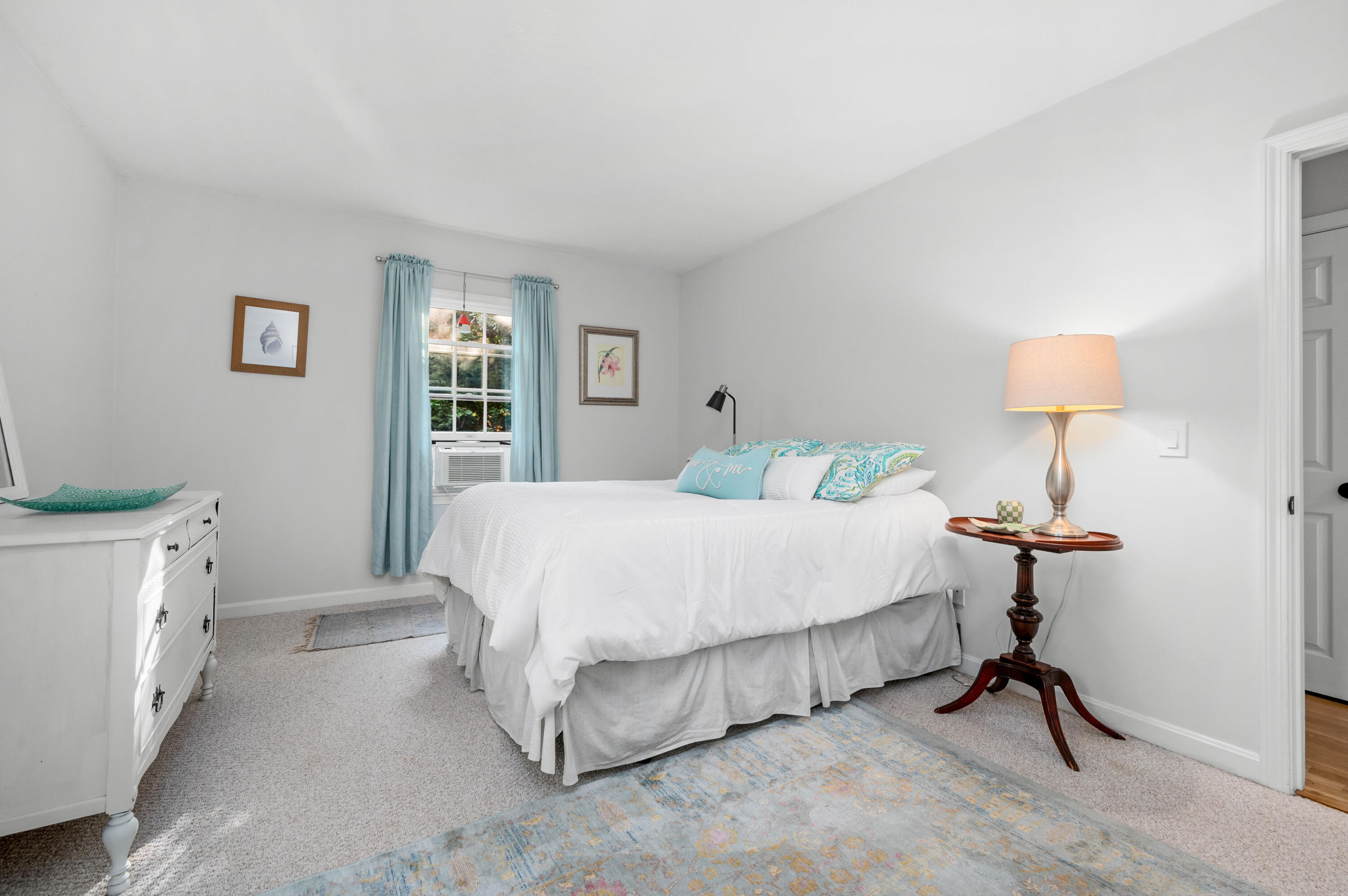 11 Quanset Road Orleans, MA 02653 - Photo 18 of 36 a bedroom with a bed and a chandelier