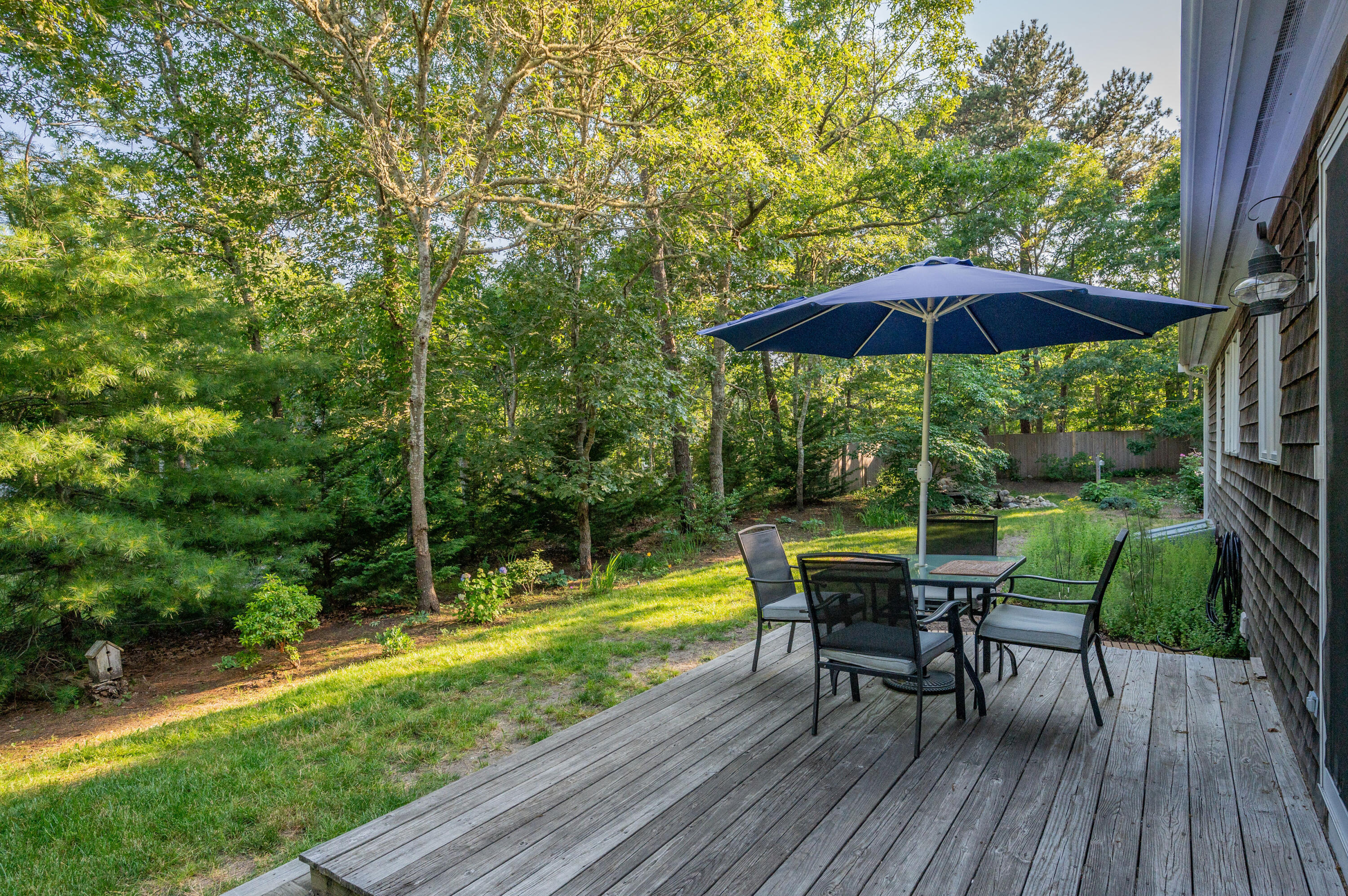 11 Quanset Road Orleans, MA 02653 - Photo 32 of 36 a view of a table and chairs under an umbrella