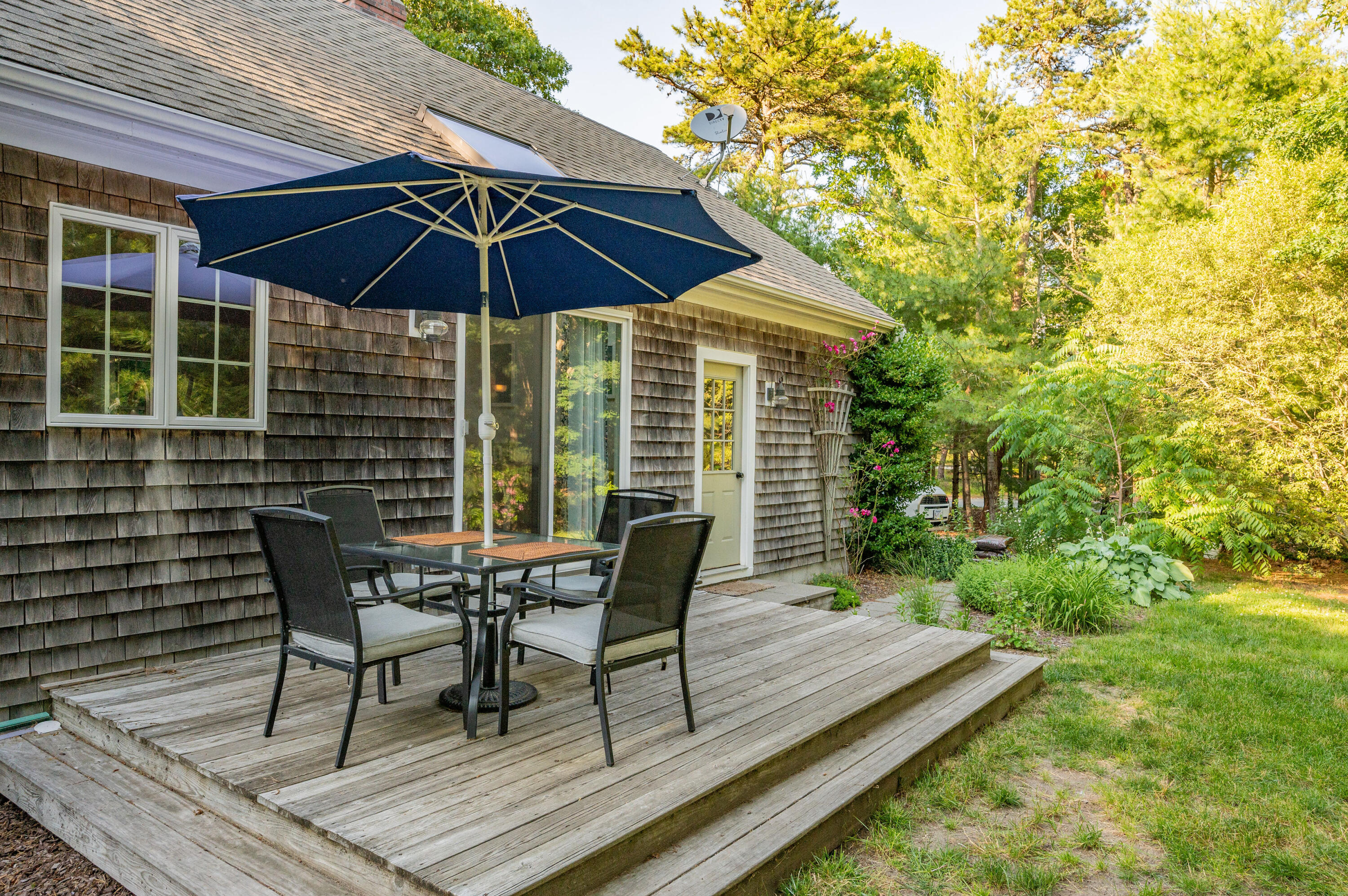 11 Quanset Road Orleans, MA 02653 - Photo 33 of 36 a patio with wooden floor and outdoor seating