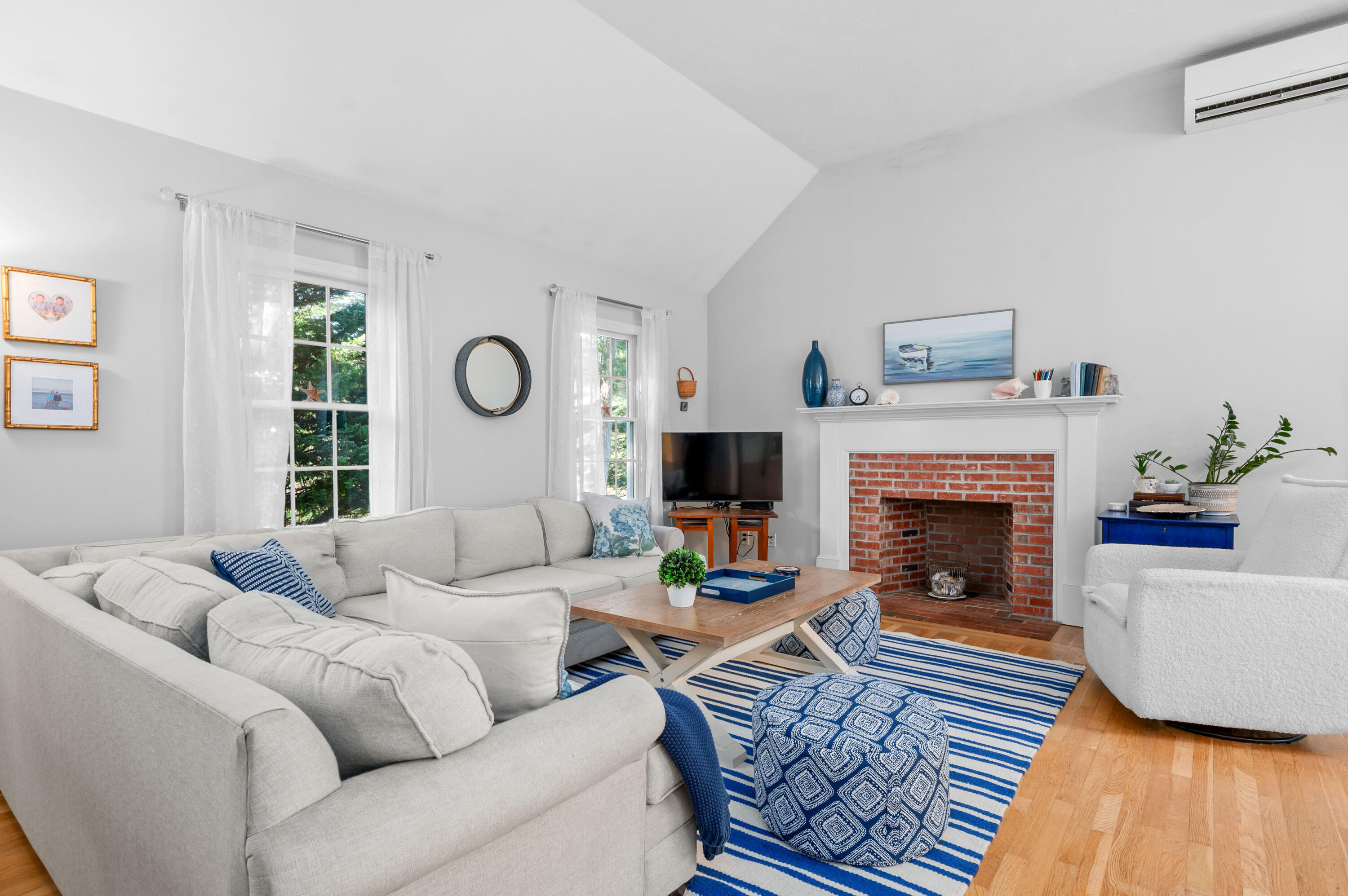 11 Quanset Road Orleans, MA 02653 - Photo 8 of 36 a living room with furniture and a fireplace