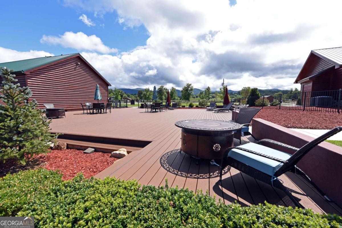 278 Foggy Mountain Road Blairsville, GA 30512 - Photo 15 of 31 a backyard of a house with table and chairs