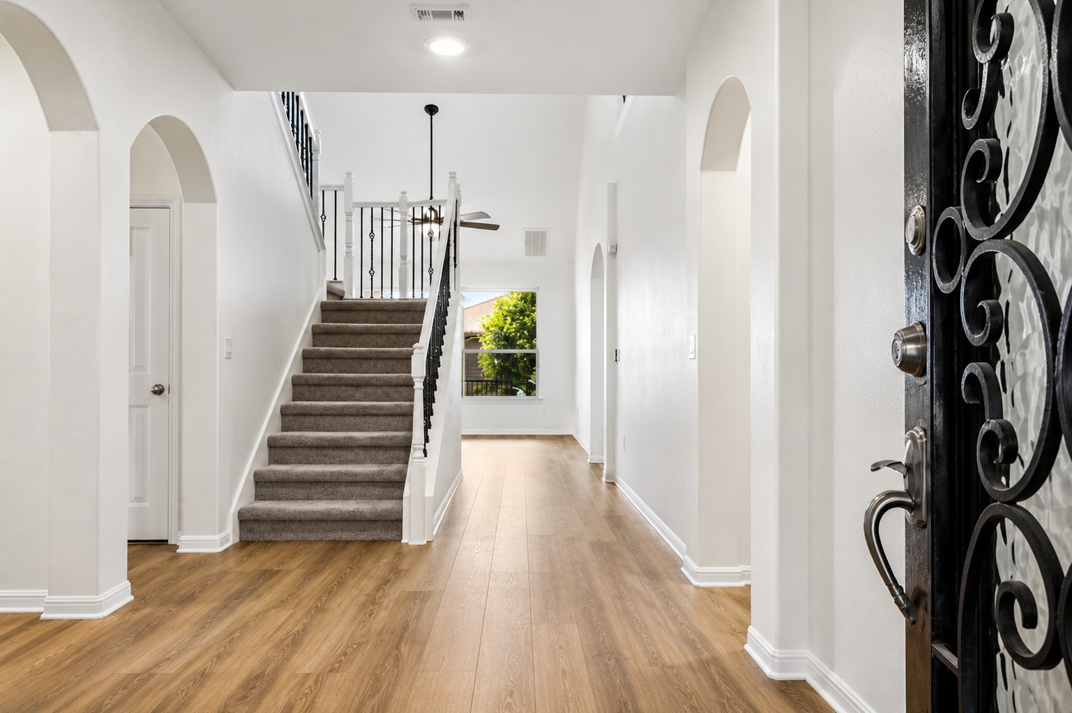 304 Santa Maria Street Georgetown, TX 78628 - Photo 4 of 37 A grand entrance welcomes you home with a sweeping staircase and rich wood flooring.