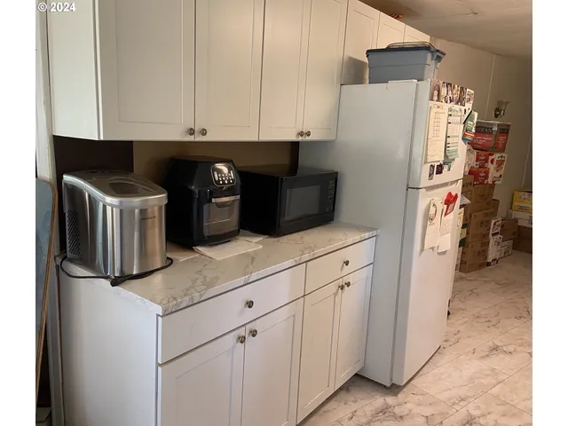 a kitchen with stainless steel appliances granite countertop a refrigerator and a stove