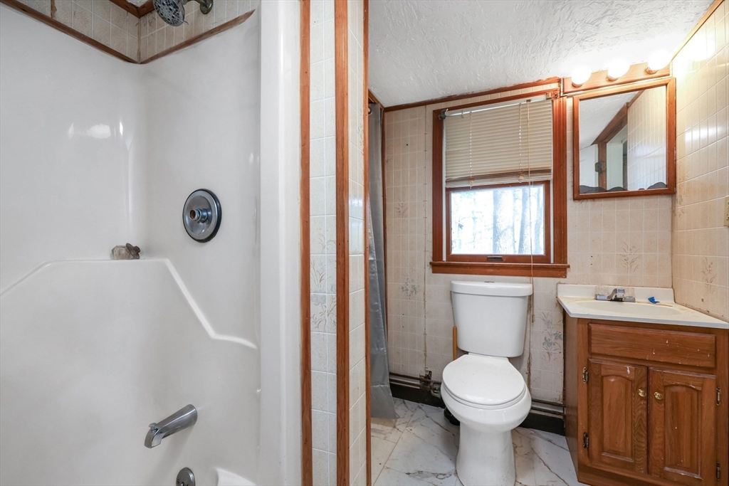 6 Hillside Road Holland, MA 01521 - Photo 18 of 27 a bathroom with a sink a toilet and shower