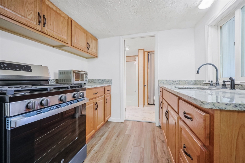 6 Hillside Road Holland, MA 01521 - Photo 5 of 27 a kitchen with stainless steel appliances granite countertop a stove and a sink