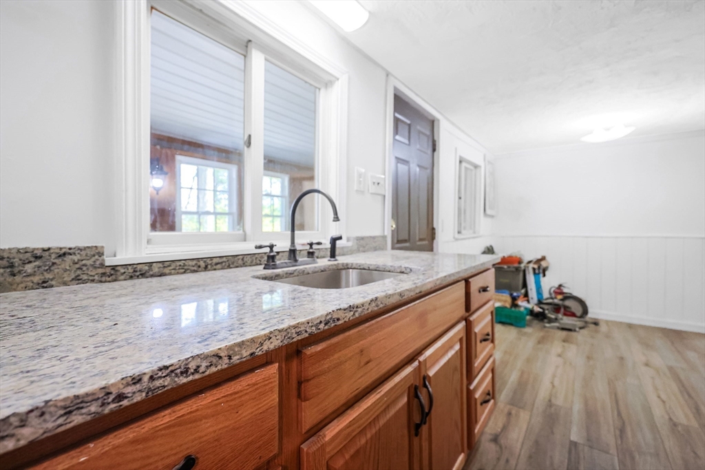 6 Hillside Road Holland, MA 01521 - Photo 7 of 27 a kitchen with a sink and a hard wood floor