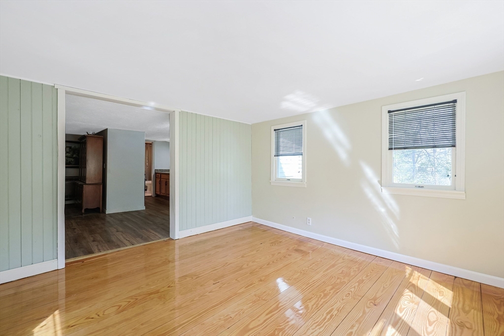 6 Hillside Road Holland, MA 01521 - Photo 9 of 27 a view of an empty room with wooden floor and a window