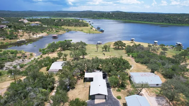 an aerial view of a house with a lake view