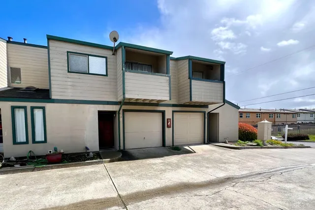 a front view of a house with a garage