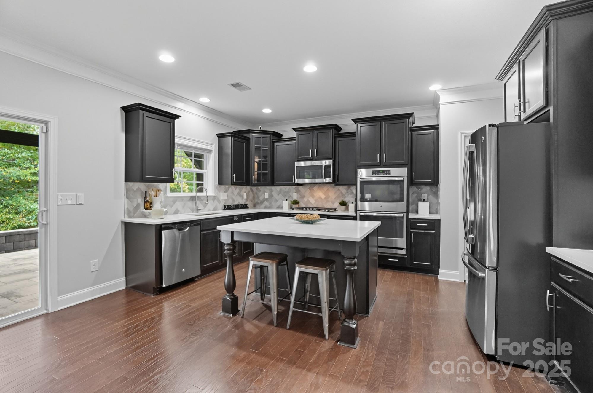 310 Annatto Way Fort Mill, SC 29708 - Photo 14 of 48 a kitchen with stainless steel appliances granite countertop a sink stove and refrigerator