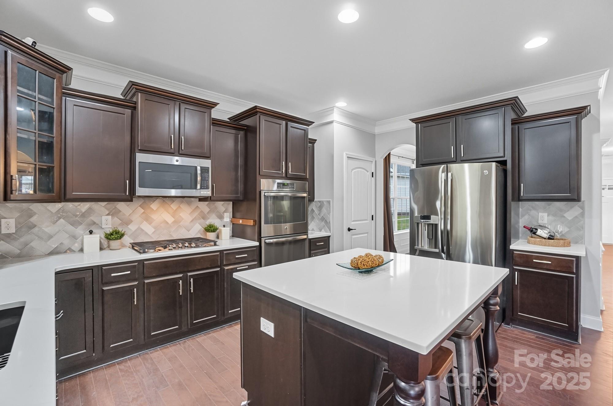310 Annatto Way Fort Mill, SC 29708 - Photo 16 of 48 a kitchen with stainless steel appliances a sink stove refrigerator and cabinets