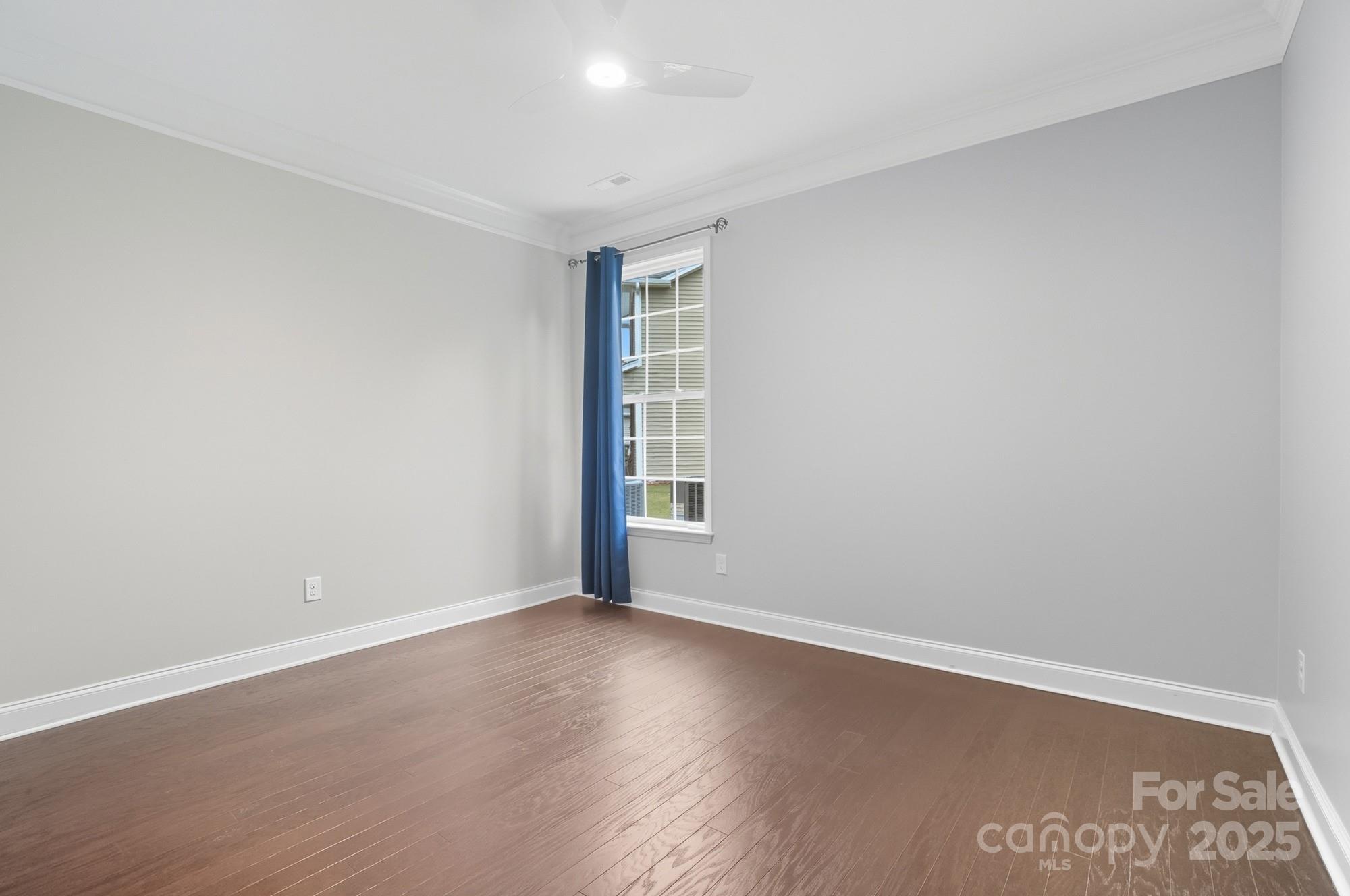 310 Annatto Way Fort Mill, SC 29708 - Photo 27 of 48 a view of an empty room with wooden floor and a window