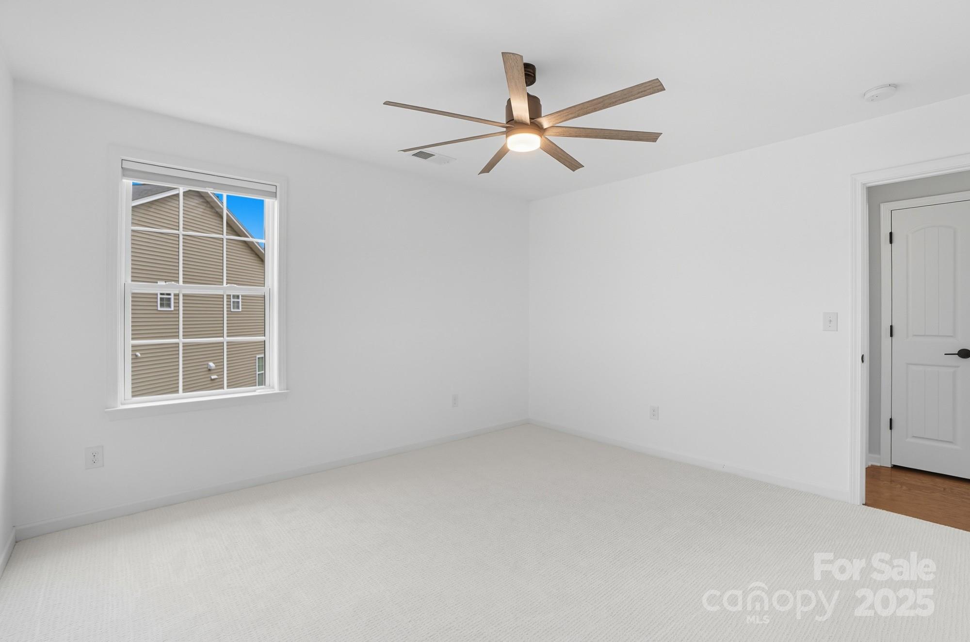 310 Annatto Way Fort Mill, SC 29708 - Photo 43 of 48 an empty room with a window and a fan