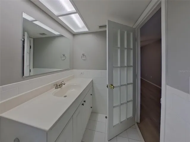 a bathroom with a tub sink and mirror