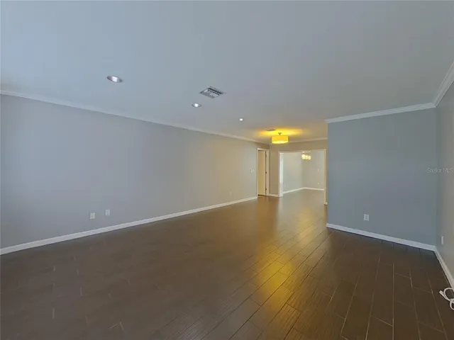 a view of room and hall with wooden floor